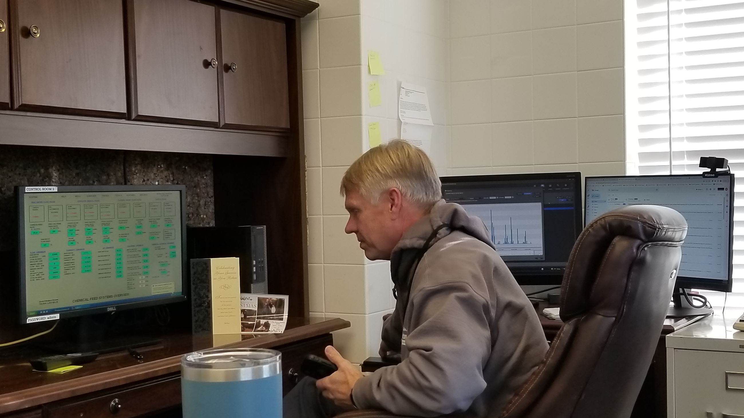 Robert Pearson at his desk on 12/21/22 helping a city water customer identify a leak.